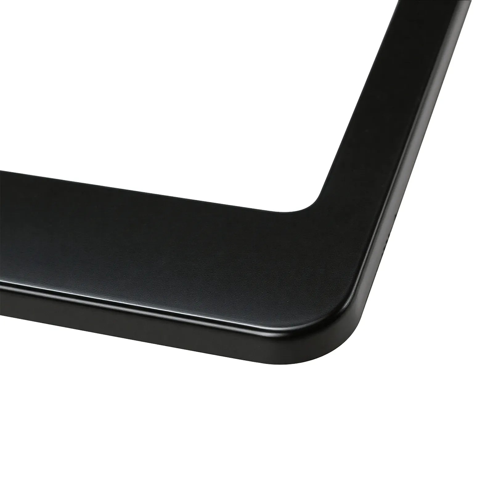 Close-up detail of the bottom corner on the Cleanstroke customizable black ABS license plate frame, highlighting the ultra-smooth, flat surface specifically designed for flawless UV printing.